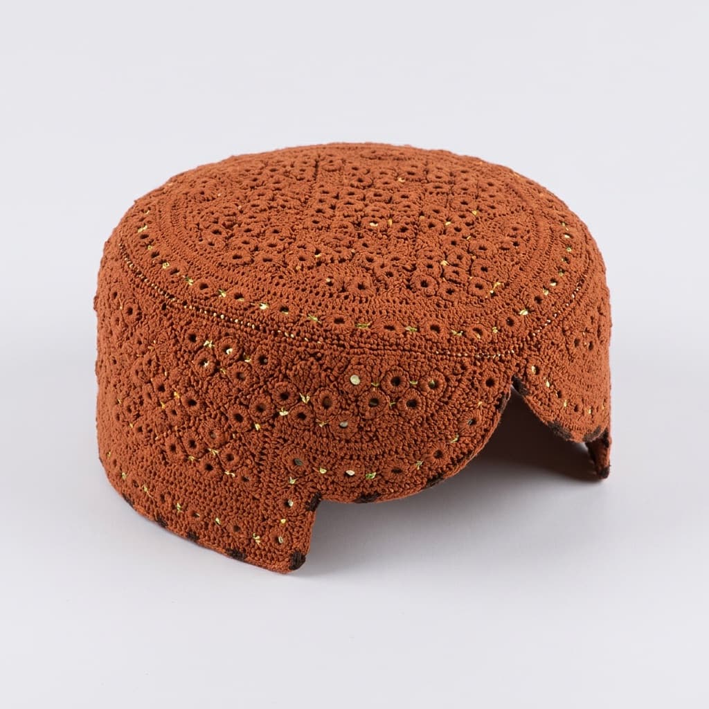 Rust orange crochet prayer cap with openwork floral texture